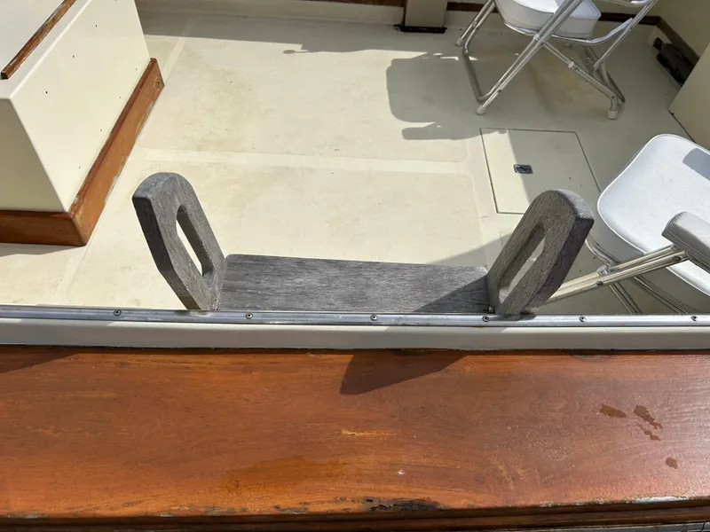 Slide: The Image of 1983 Fortier 26 boat interior with wooden trim and seating. - 11