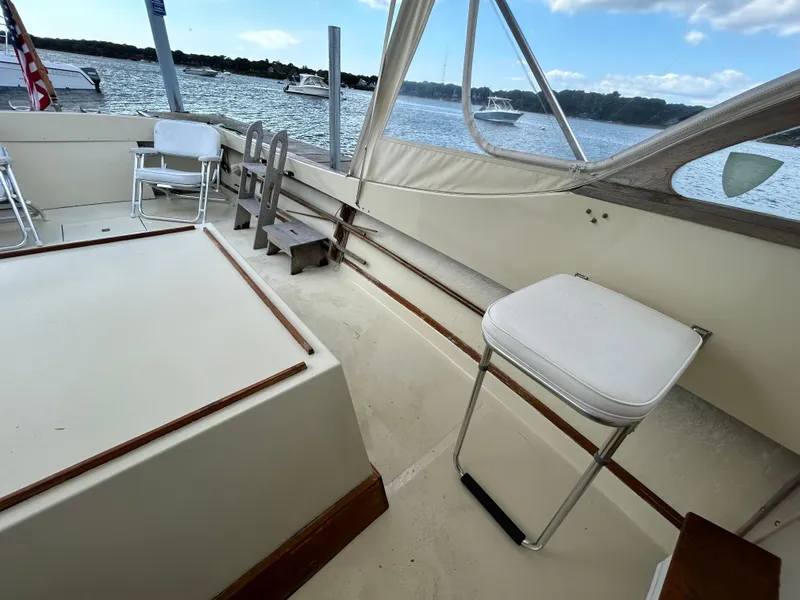 Slide: The Image of 1983 Fortier 26 boat interior with seating, overlooking a scenic waterfront. - 18