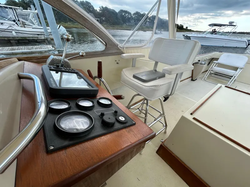 Slide: The Image of 1983 Fortier 26 boat cockpit with steering controls and captain's chair. - 2