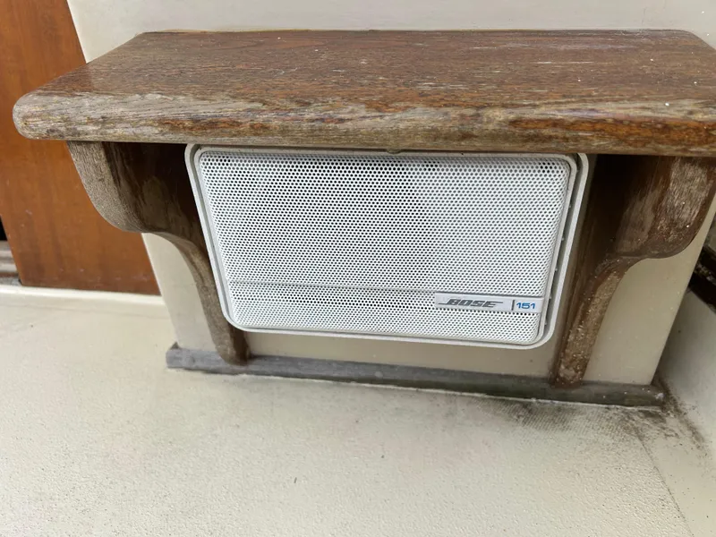 Slide: The Image of Bose speaker mounted on a 1983 Fortier 26 boat with wooden shelf. - 23