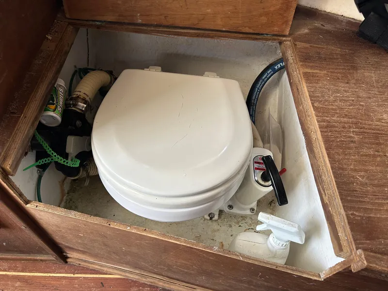 Slide: The Image of Boat toilet in 1983 Fortier 26, compact marine head with wooden enclosure. - 25