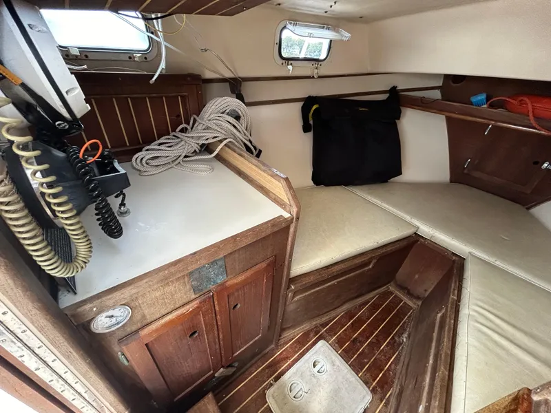 Slide: The Image of Interior of 1983 Fortier 26 boat with wooden cabinetry and seating area. - 28
