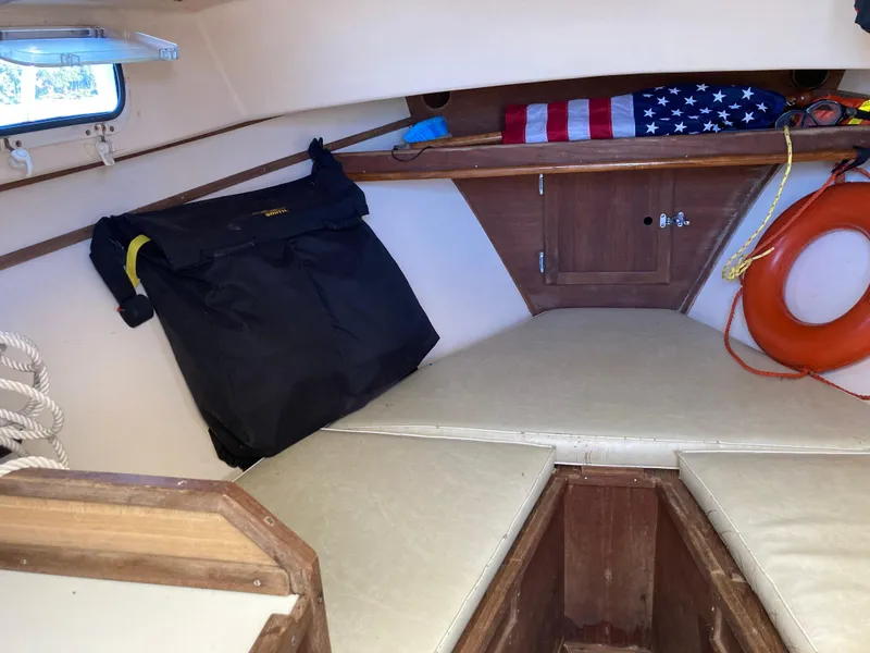 Slide: The Image of Interior of 1983 Fortier 26 boat with American flag and life preserver. - 3