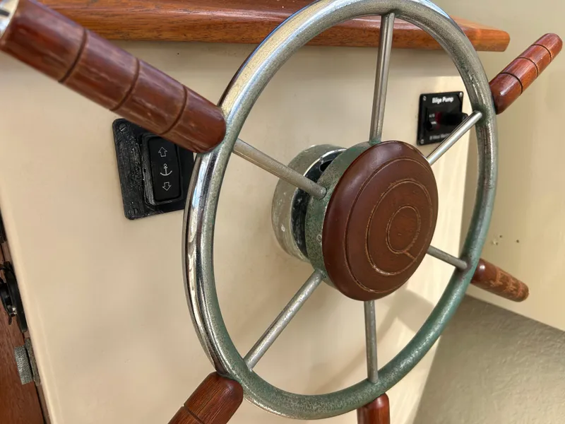 Slide: The Image of Close-up of 1983 Fortier 26 boat steering wheel with wooden handles. - 31