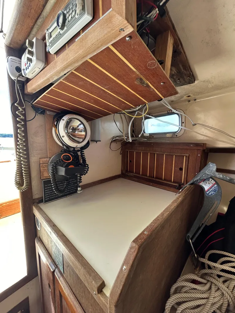 Slide: The Image of 1983 Fortier 26 boat interior with navigation equipment and wooden cabinetry. - 34