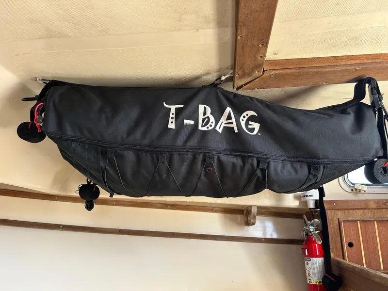 Slide: The Image of Black T-Bag storage on 1983 Fortier 26 boat interior. - 38