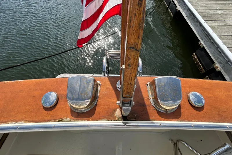 Slide: The Image of 1983 Fortier 26 boat deck with American flag, docked by the water. - 40