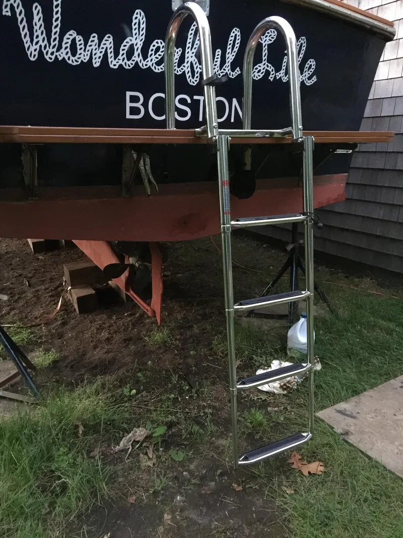 Slide: The Image of 1983 Fortier 26 boat with ladder, named "Wonderful Life," docked in Boston. - 44