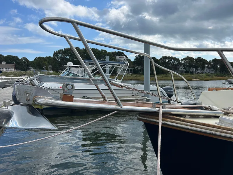 Slide: The Image of 1983 Fortier 26 boat docked in a marina under cloudy skies. - 7