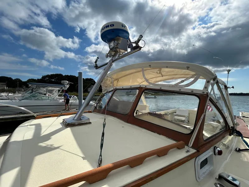 Slide: The Image of 1983 Fortier 26 boat with radar, docked under a cloudy sky. - 9