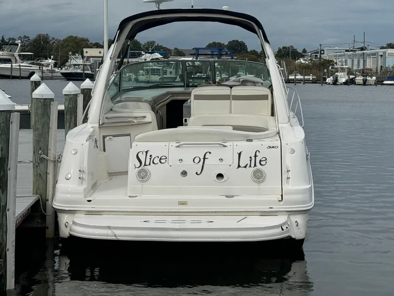 Slide: The Image of 2003 Sea Ray 320 Sundancer boat named "Slice of Life" docked at marina. - 17