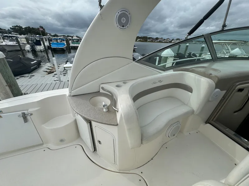 Slide: The Image of 2003 Sea Ray 320 Sundancer boat interior with seating and dock view. - 19