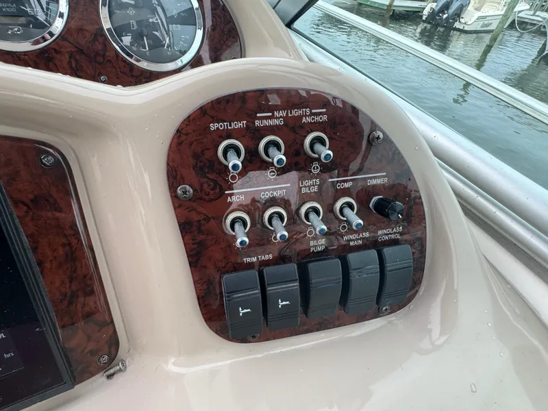 Slide: The Image of Control panel of a 2003 Sea Ray 320 Sundancer boat with switches and dials. - 28
