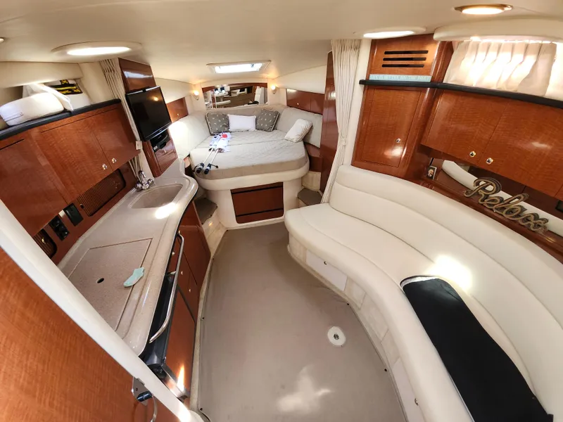 Slide: The Image of Luxurious interior of 2003 Sea Ray 320 Sundancer yacht with cozy seating and elegant wood finishes. - 32