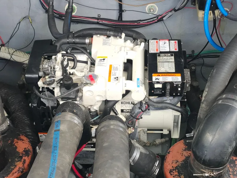 Slide: The Image of Engine compartment of a 2003 Sea Ray 320 Sundancer with visible Kohler generator. - 43