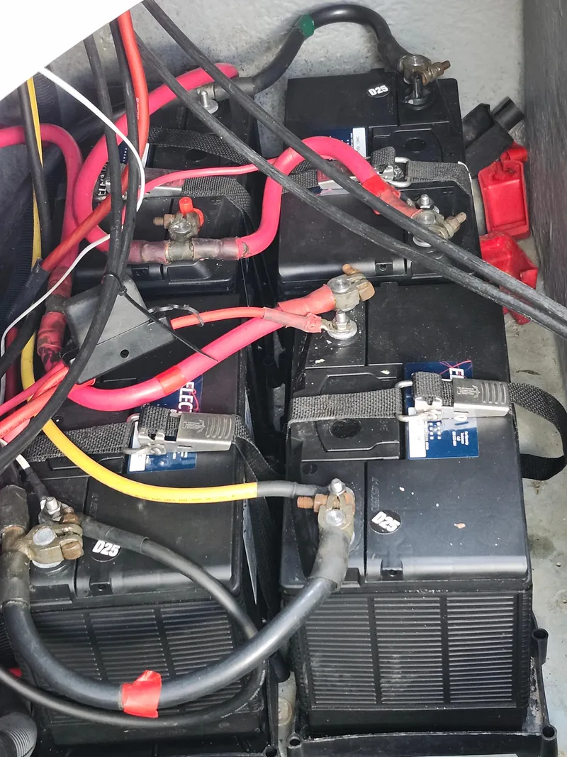 Slide: The Image of Battery compartment of a 2003 Sea Ray 320 Sundancer with multiple connected batteries. - 44