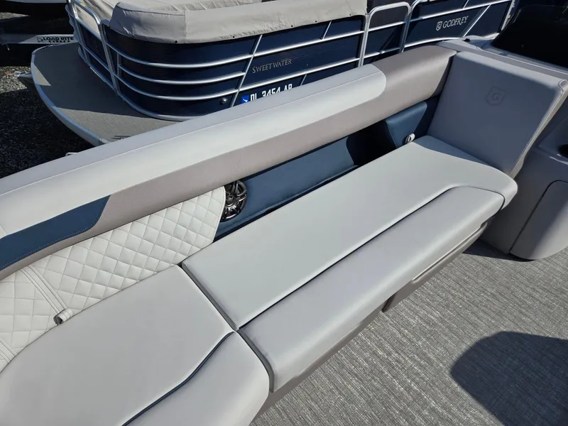Slide: The Image of 2025 Godfrey SWEETWATER Entertainment 2486 DT boat seating, featuring sleek gray upholstery. - 10