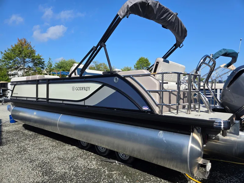 Slide: The Image of 2025 Godfrey SWEETWATER Entertainment 2486 DT pontoon boat on display. - 2