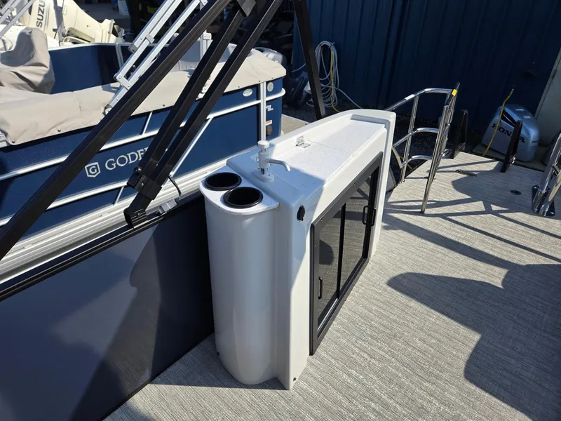Slide: The Image of 2025 Godfrey SWEETWATER Entertainment 2486 DT boat interior with storage and cup holders. - 21