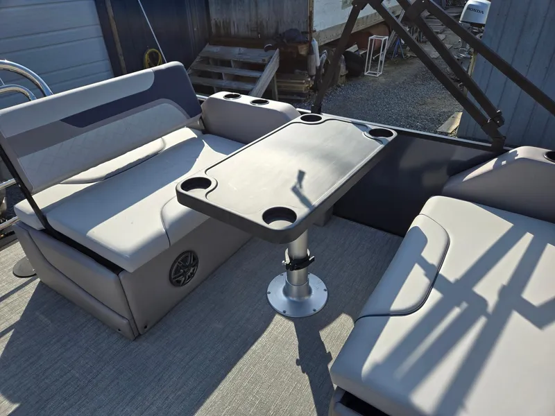 Slide: The Image of 2025 Godfrey SWEETWATER Entertainment 2486 DT boat interior with seating and table. - 22