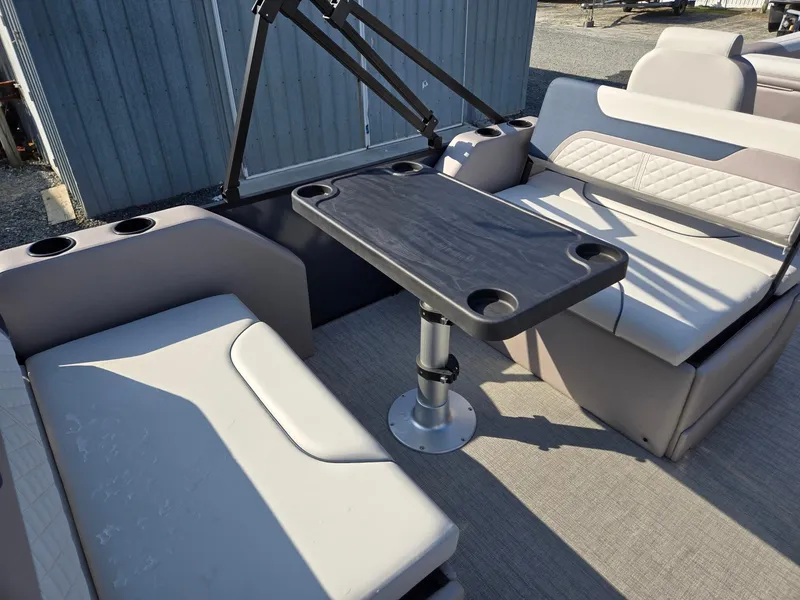 Slide: The Image of 2025 Godfrey SWEETWATER Entertainment 2486 DT boat interior with seating and table. - 23