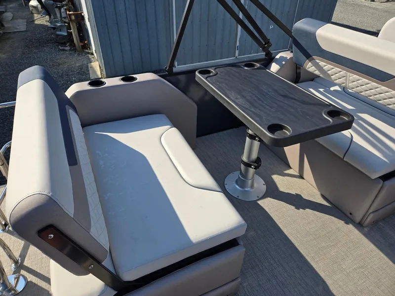 Slide: The Image of 2025 Godfrey SWEETWATER Entertainment 2486 DT boat interior with seating and table. - 24