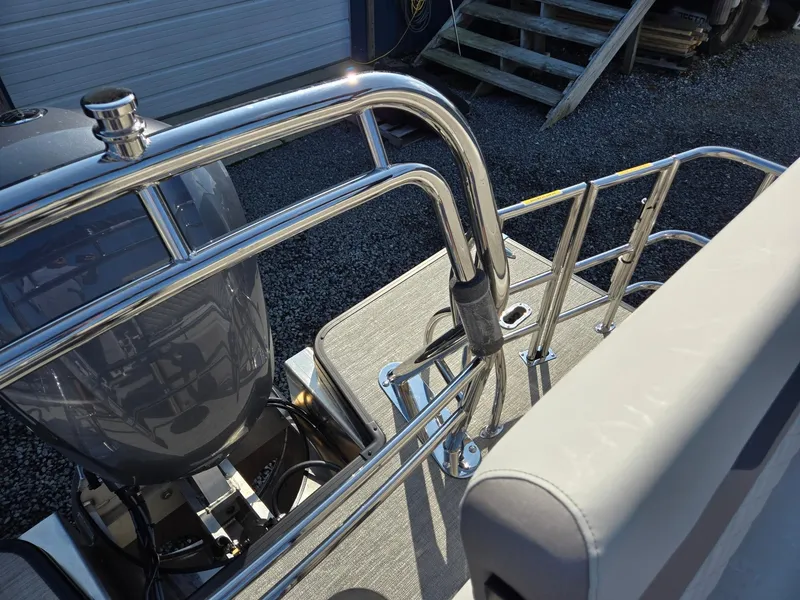 Slide: The Image of 2025 Godfrey SWEETWATER Entertainment 2486 DT boat with stainless steel railings and motor. - 29