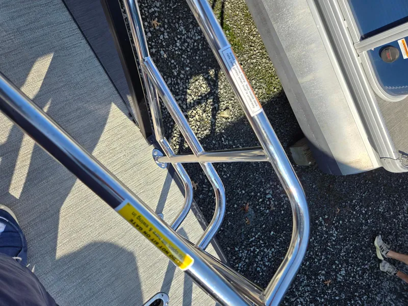 Slide: The Image of Close-up of 2025 Godfrey SWEETWATER Entertainment 2486 DT boat railing and deck. - 32