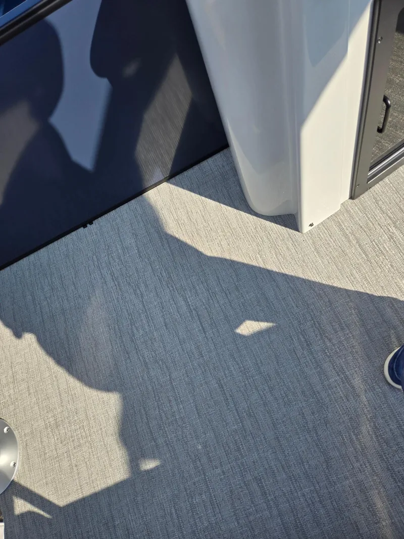 Slide: The Image of 2025 Godfrey SWEETWATER Entertainment 2486 DT boat interior with textured flooring. - 33