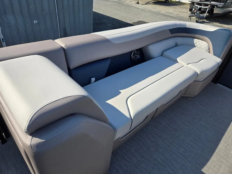 Slide: The Image of 2025 Godfrey SWEETWATER Entertainment 2486 DT boat seating, gray upholstery, outdoor setting. - 39