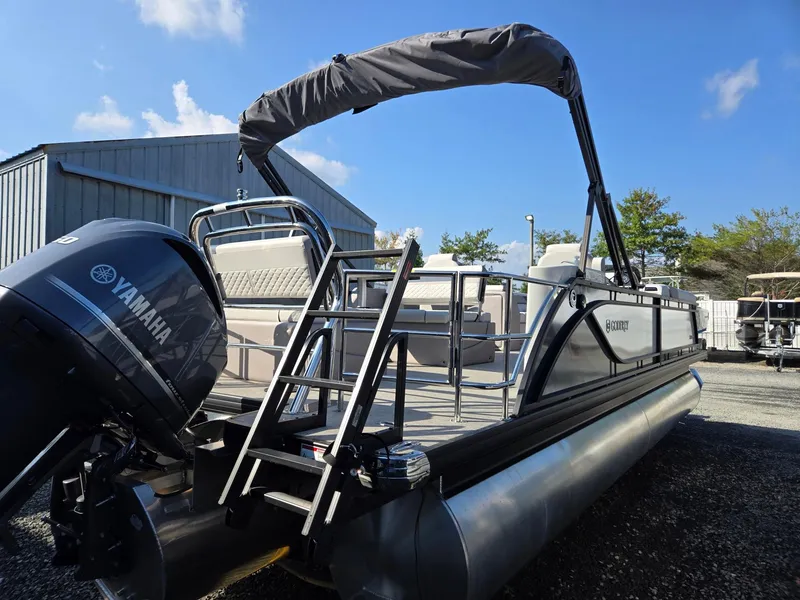 Slide: The Image of 2025 Godfrey SWEETWATER Entertainment 2486 DT pontoon boat with Yamaha engine, docked outdoors. - 5