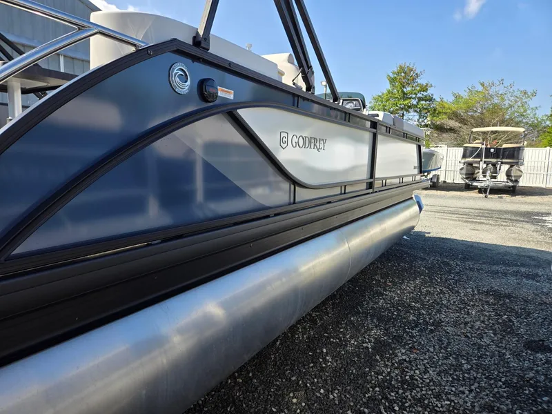 Slide: The Image of 2025 Godfrey SWEETWATER Entertainment 2486 DT pontoon boat, sleek design, outdoor setting. - 6