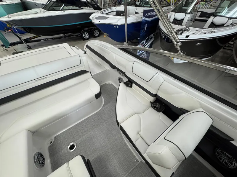 Slide: The Image of 2025 Formula 240 BR boat interior with white seating and sleek design. - 11