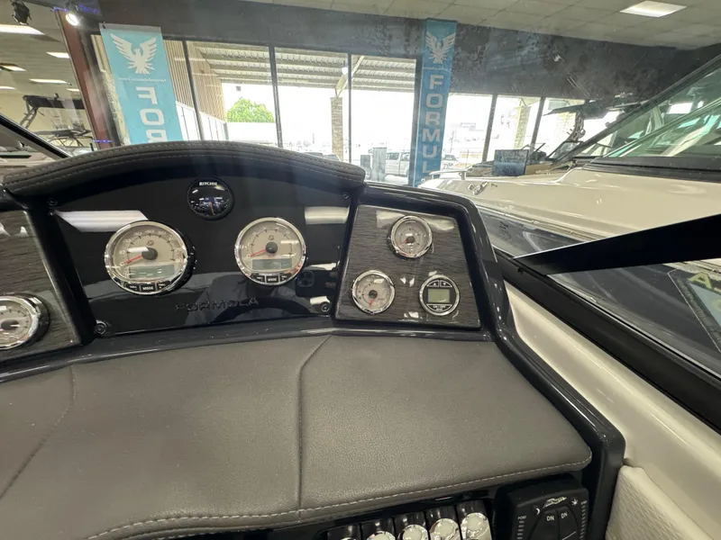 Slide: The Image of Dashboard of 2025 Formula 240 BR boat with gauges and controls in showroom. - 20