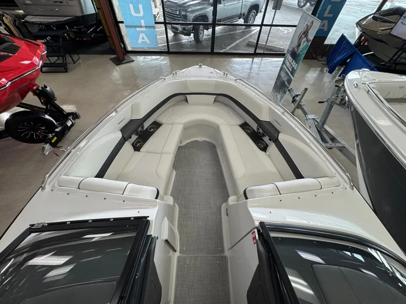 Slide: The Image of 2025 Formula 240 BR boat interior with spacious seating, displayed in showroom. - 24
