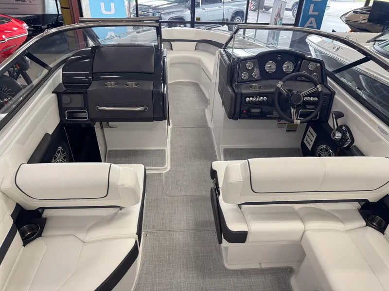 Slide: The Image of Interior of a 2025 Formula 240 BR boat with white seating and modern dashboard. - 9