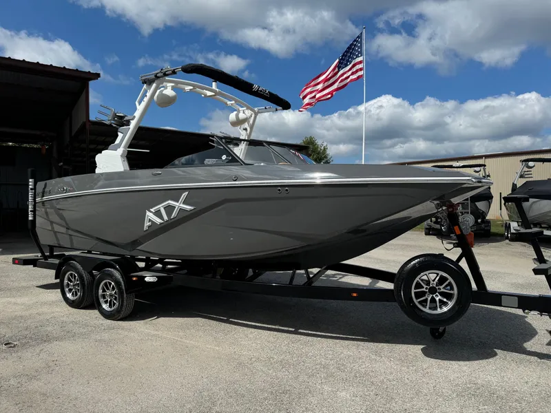 The Image of 2025 ATX Surf Boats 22 Type-S on trailer, American flag in background. - 0