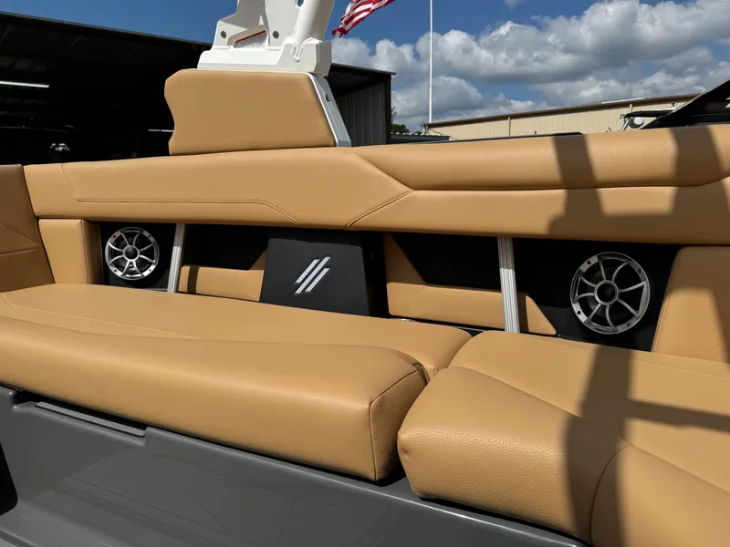 Slide: The Image of 2025 ATX Surf Boats 22 Type-S interior with tan seating and built-in speakers. - 11