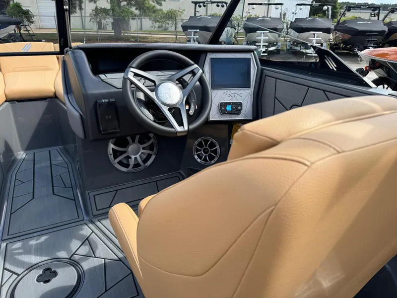 Slide: The Image of 2025 ATX Surf Boats 22 Type-S interior with tan seats and modern dashboard. - 7