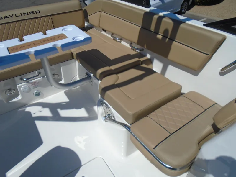 Slide: The Image of 2025 Bayliner D22I boat interior with tan seating and stainless steel accents. - 10
