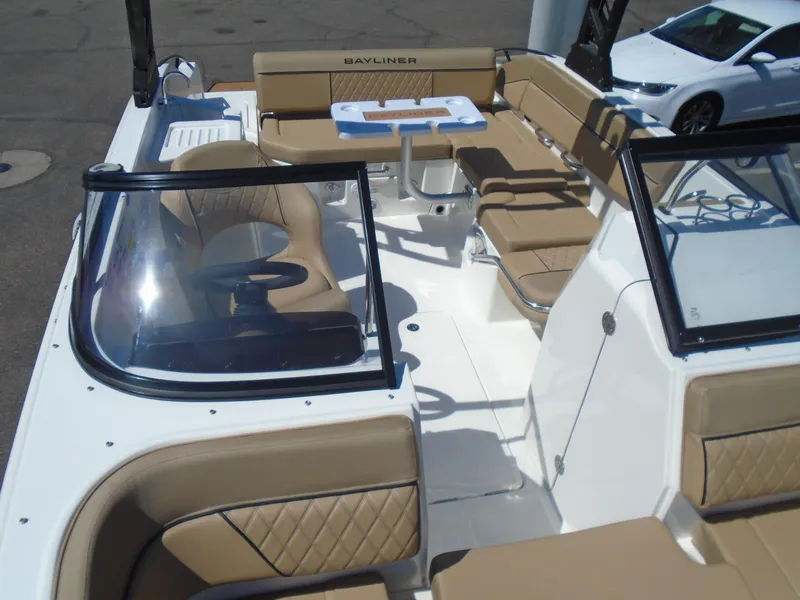Slide: The Image of 2025 Bayliner D22I boat interior with tan seating and steering wheel. - 11