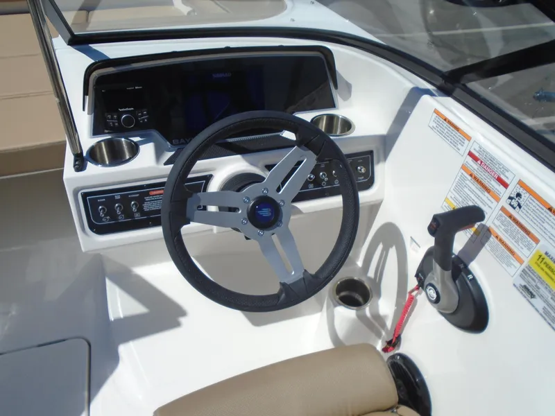 Slide: The Image of 2025 Bayliner D22I boat dashboard with steering wheel and control panel. - 12