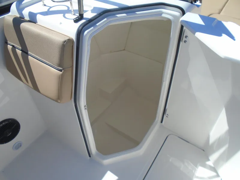 Slide: The Image of 2025 Bayliner D22I boat interior with cushioned seating and storage compartment. - 14