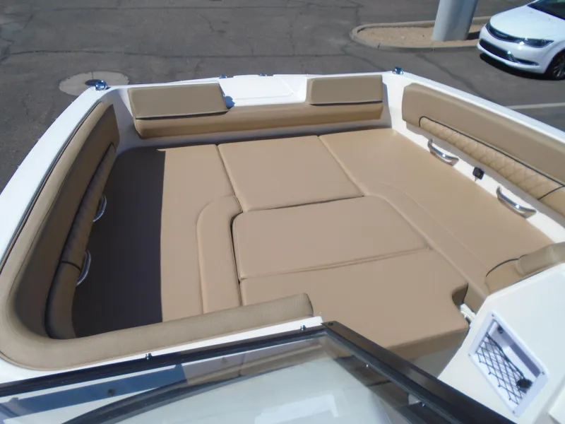 Slide: The Image of 2025 Bayliner D22I boat interior with beige seating and spacious layout. - 17