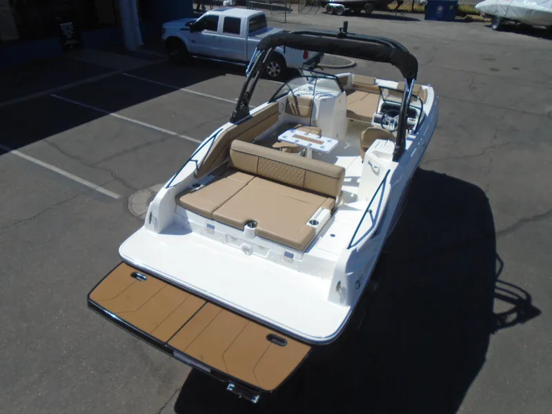Slide: The Image of 2025 Bayliner D22I boat with tan seating, parked in a lot. - 4