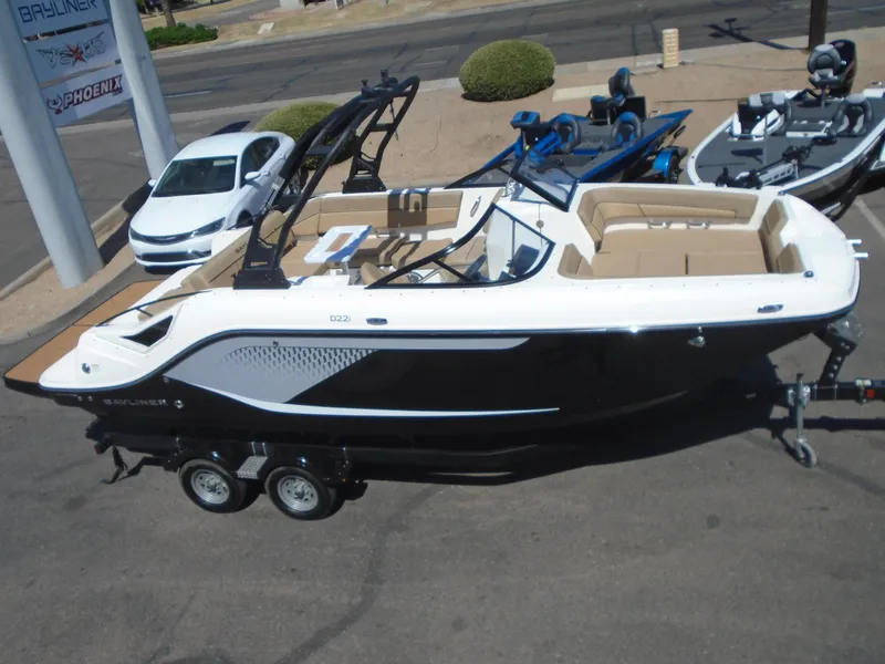 Slide: The Image of 2025 Bayliner D22I boat on trailer, sleek design, parked outdoors. - 6