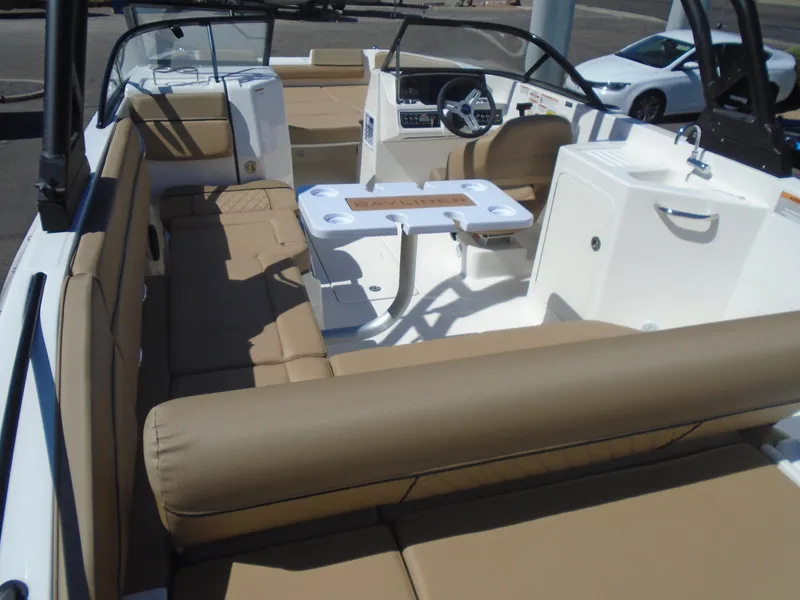 Slide: The Image of 2025 Bayliner D22I boat interior with tan seating and a small table. - 8