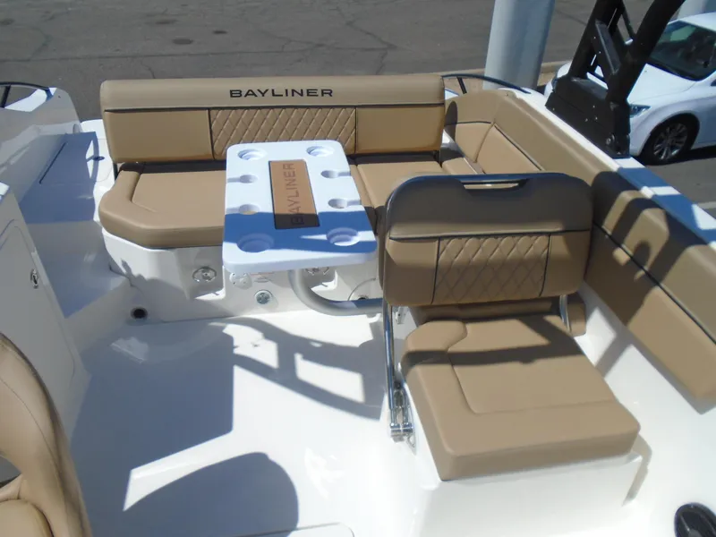 Slide: The Image of 2025 Bayliner D22I boat interior with tan seating and table, showcasing luxury design. - 9