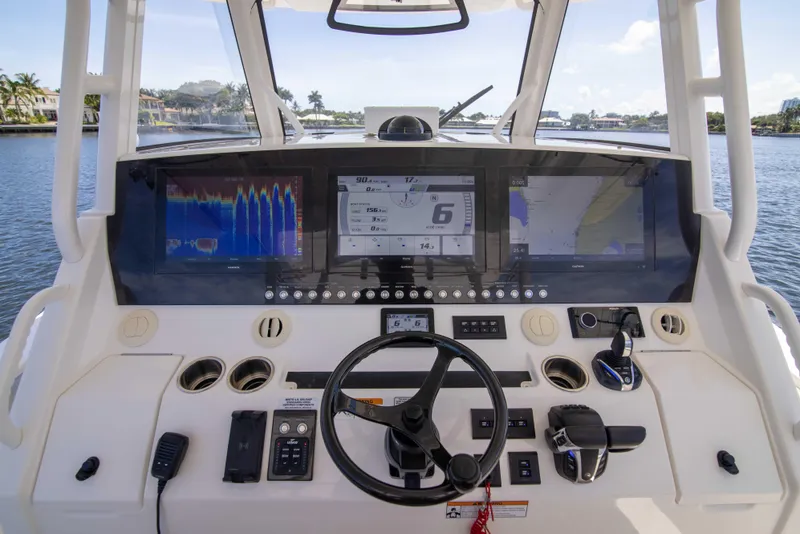Slide: The Image of 2021 Regulator 41 boat helm with advanced navigation displays and controls. - 1