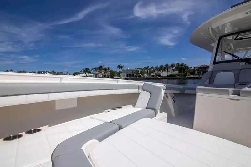 Slide: The Image of 2021 Regulator 41 boat interior with seating, under a clear blue sky. - 14